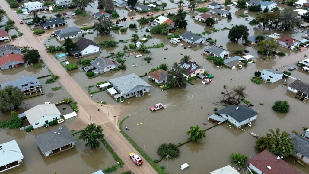 Flooded neighborhoods with submerged homes and streets.